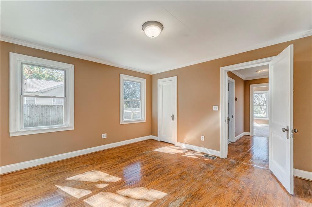 2501 Maple Road Southeast Rome, GA 30161 - Photo 30 of 56 a view of an empty room with wooden floor and a window