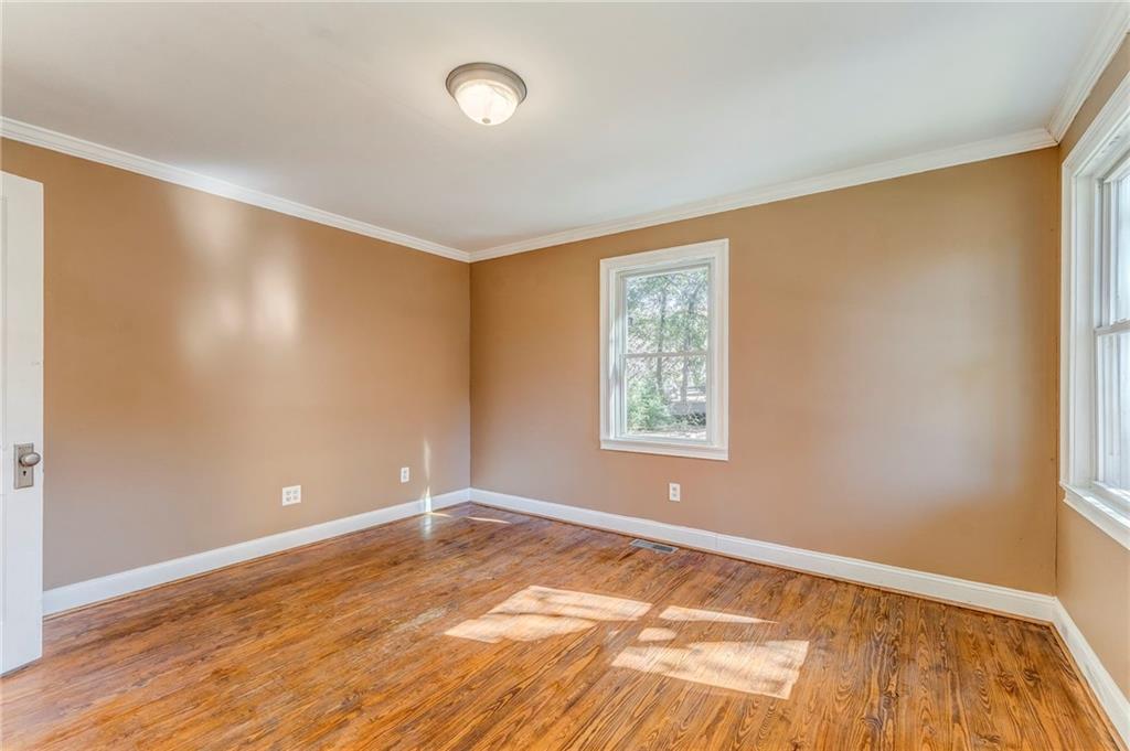 2501 Maple Road Southeast Rome, GA 30161 - Photo 32 of 56 a view of an empty room with wooden floor and a window