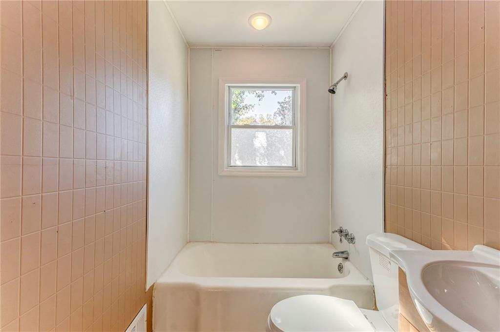 2501 Maple Road Southeast Rome, GA 30161 - Photo 36 of 56 a white bath tub sitting next to a toilet