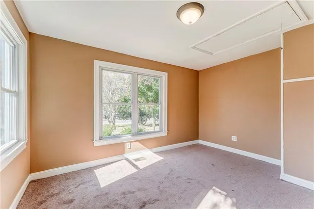a bedroom with a large bed and a large window