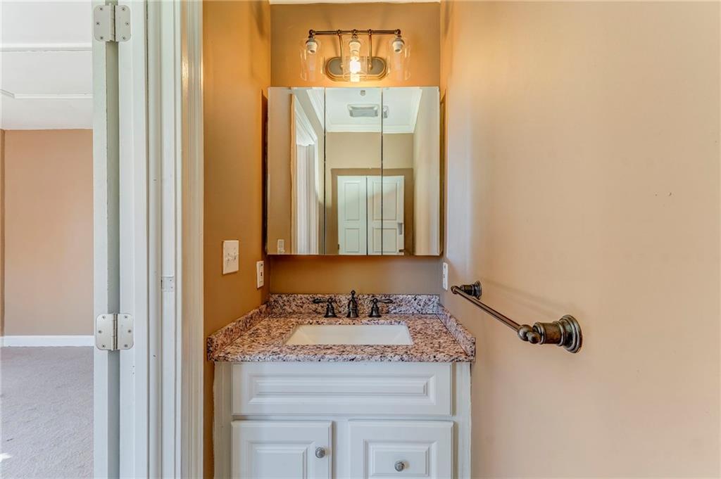 2501 Maple Road Southeast Rome, GA 30161 - Photo 42 of 56 a bathroom with a granite countertop sink a mirror and a vanity