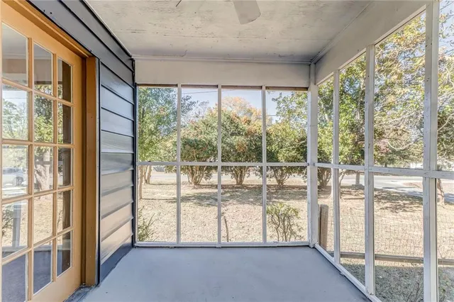 a front view of a house with a yard covered in snow