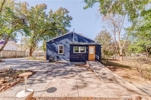 a view of a yard with plants and trees