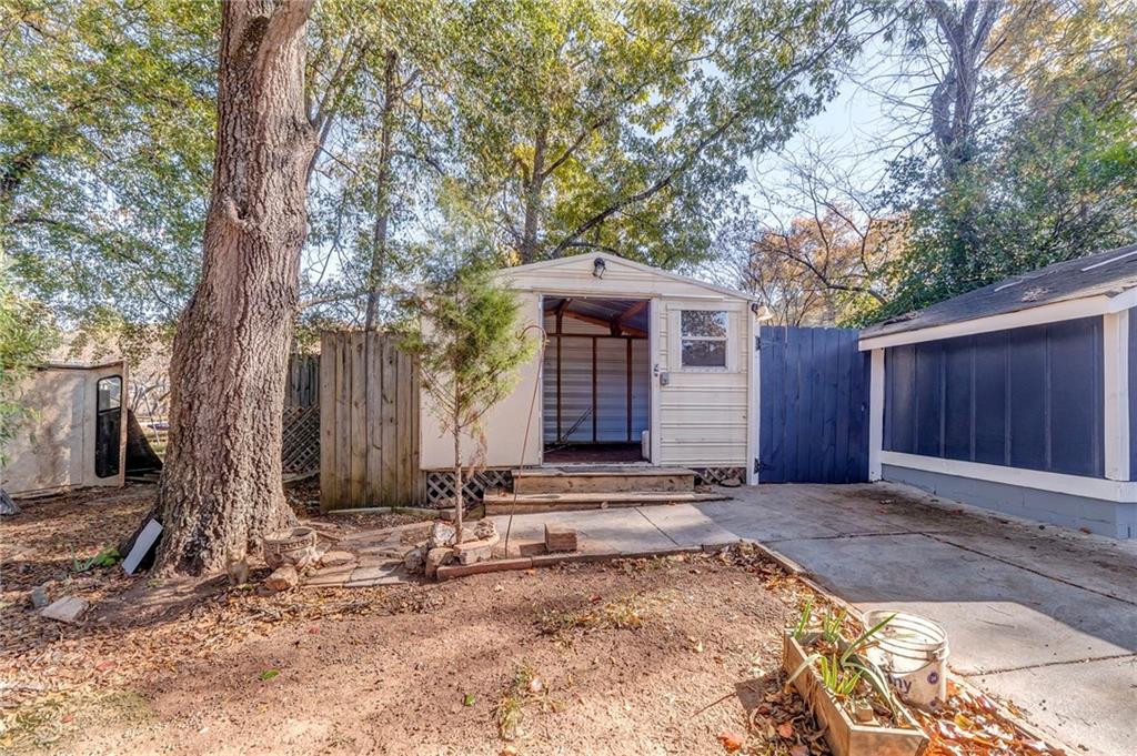 2501 Maple Road Southeast Rome, GA 30161 - Photo 52 of 56 a front view of a house with yard tree and wooden fence