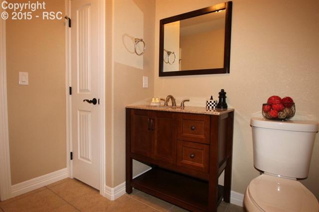 11420 Teachout Road Colorado Springs, CO 80908 - Photo 20 of 36 Second full bath on main level services bedrooms two and three, and is beautifully appointed for your guests as well.