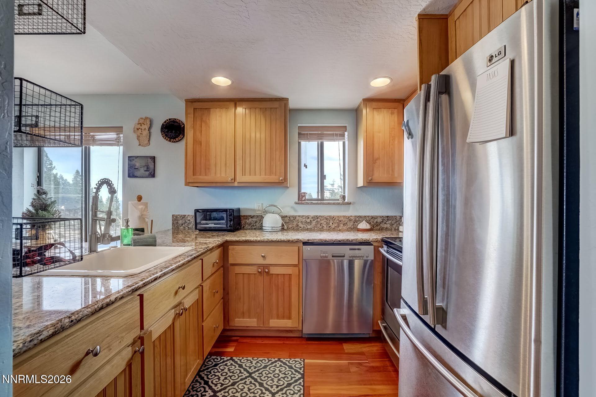 495 Tramway Drive, Unit 7 Stateline, NV 89449 - Photo 12 of 31 a kitchen with stainless steel appliances granite countertop a refrigerator and a sink