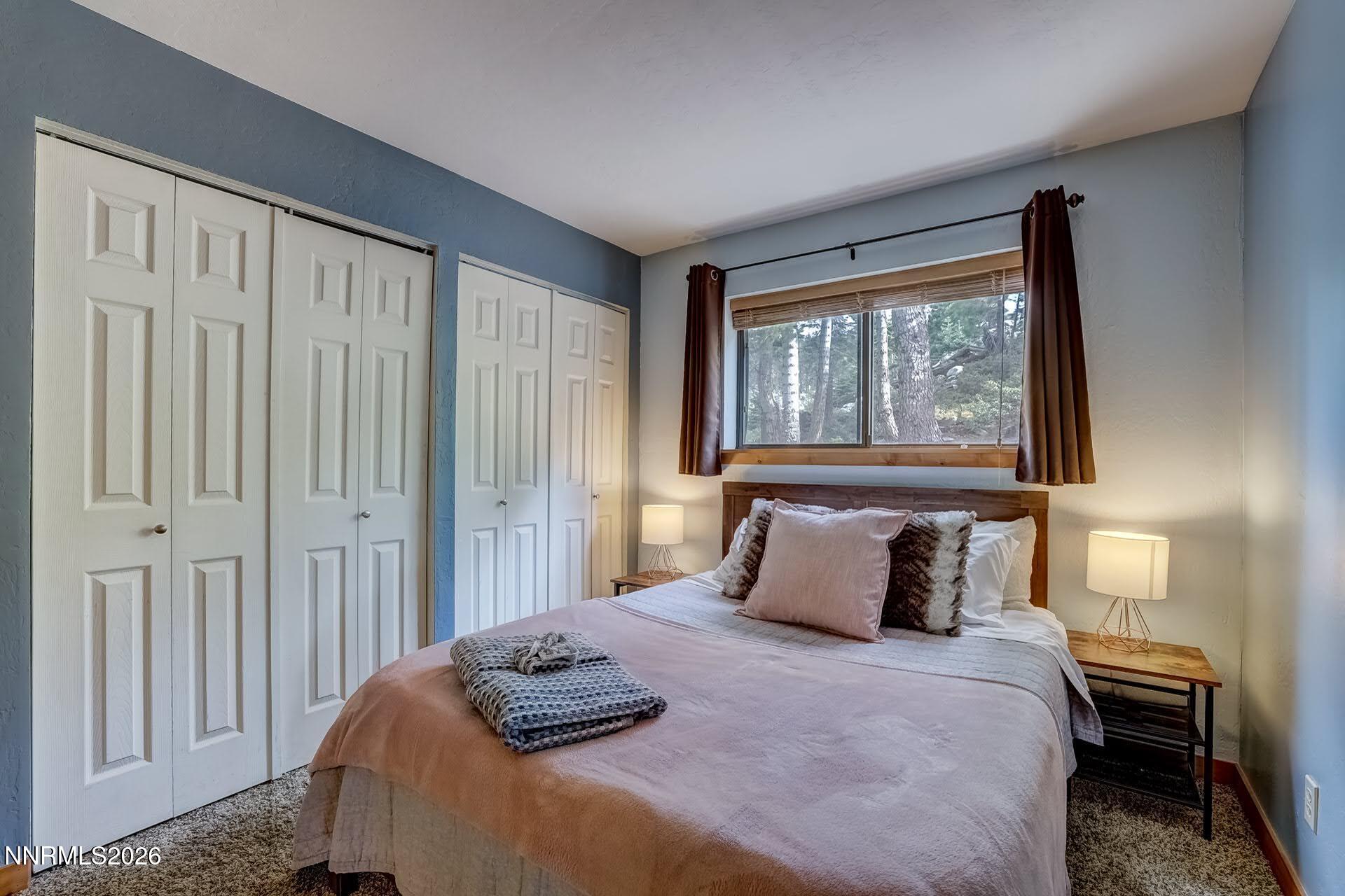 495 Tramway Drive, Unit 7 Stateline, NV 89449 - Photo 14 of 31 a bedroom with a bed and a window