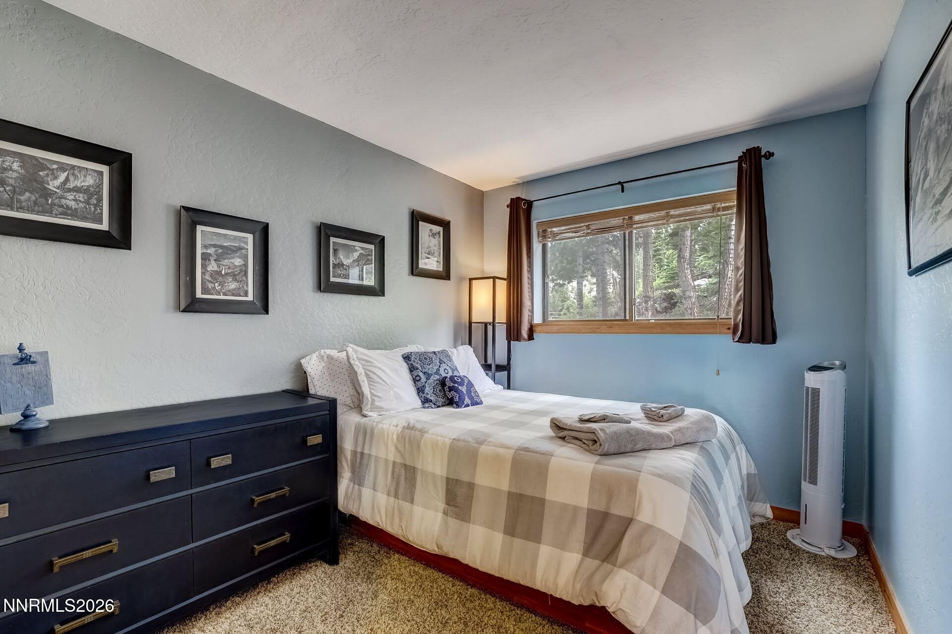 495 Tramway Drive, Unit 7 Stateline, NV 89449 - Photo 17 of 31 a bedroom with a bed and a window