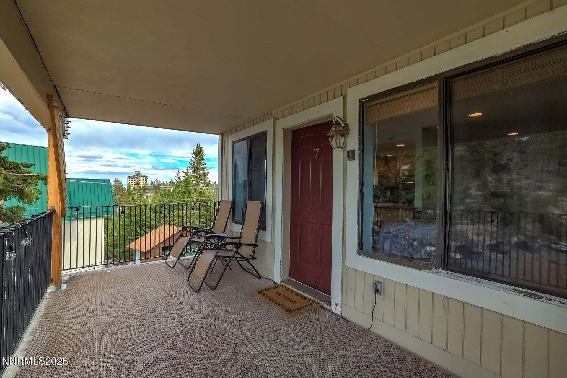495 Tramway Drive, Unit 7 Stateline, NV 89449 - Photo 4 of 31 a view of a balcony with chairs and floor to ceiling window