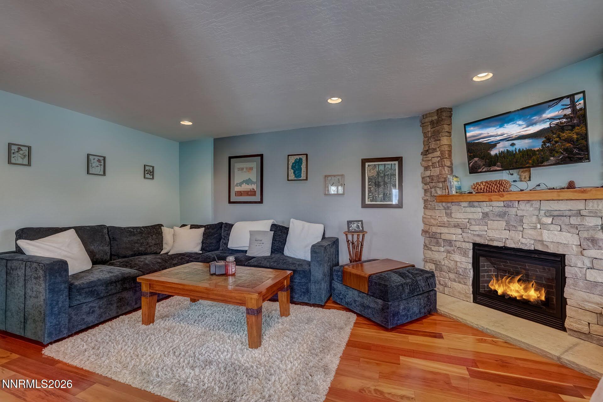 495 Tramway Drive, Unit 7 Stateline, NV 89449 - Photo 6 of 31 a living room with furniture a flat screen tv and a fireplace