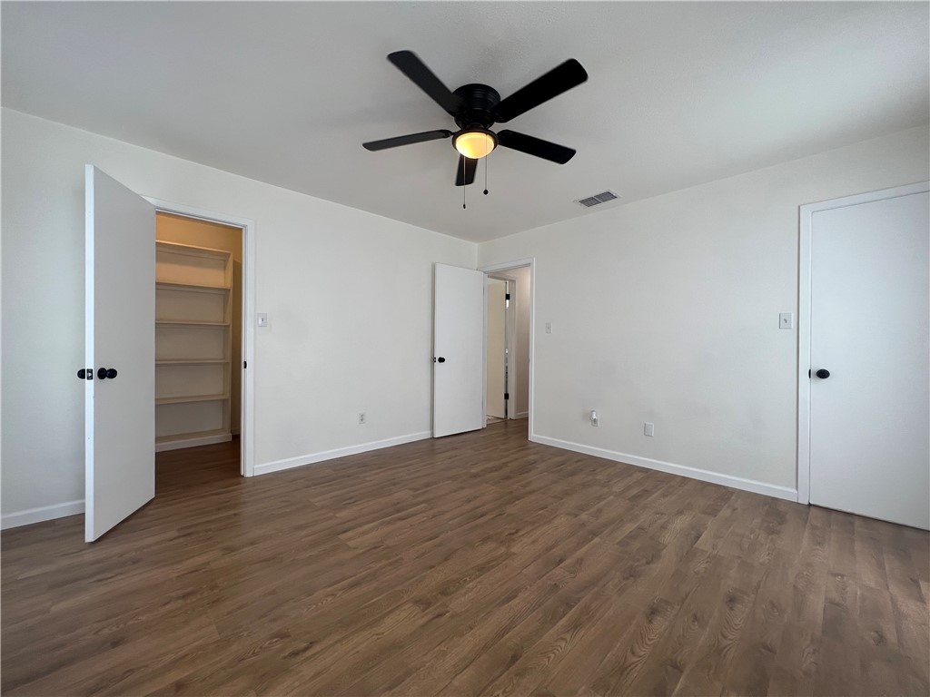 Undisclosed Address Corpus Christi, TX 78418 - Photo 13 of 20 a view of an empty room with wooden floor and a ceiling fan