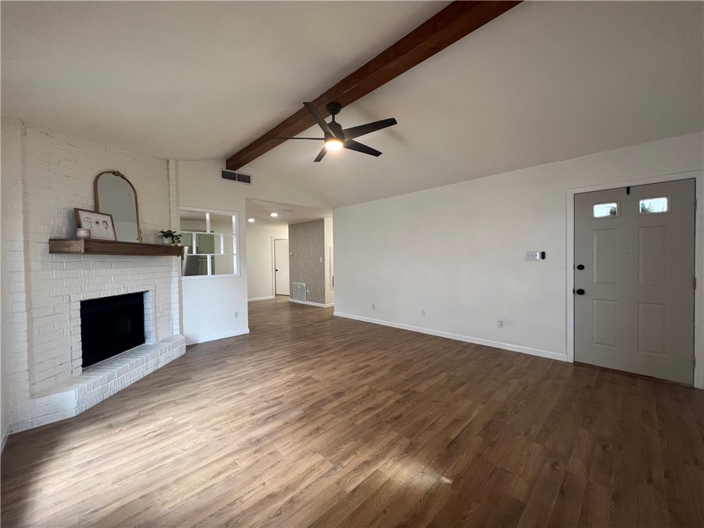 Undisclosed Address Corpus Christi, TX 78418 - Photo 3 of 20 a view of empty room with wooden floor and fireplace
