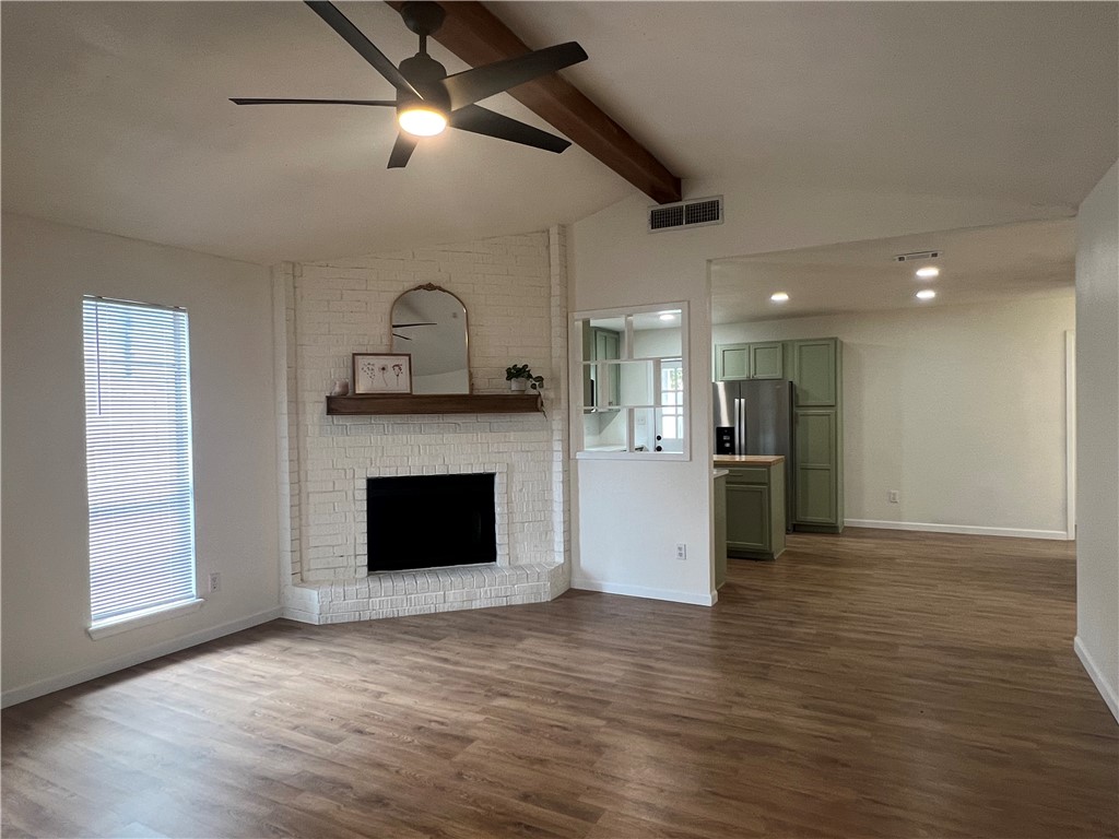 Undisclosed Address Corpus Christi, TX 78418 - Photo 4 of 20 a view of kitchen and empty room with wooden floor fireplace