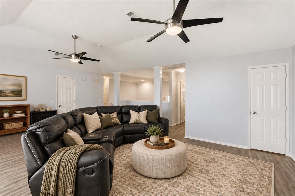 2112 Loon Lake Road Denton, TX 76210 - Photo 22 of 37 Vaulted ceiling, two contemporary ceiling fans, wood-finish flooring, light-toned walls, and white paneled interior doors