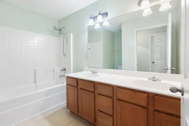 a bathroom with a tub sink double and mirror
