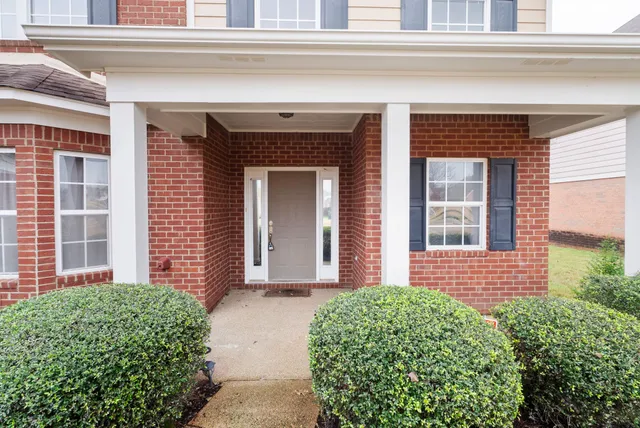 a front view of a house with a garden