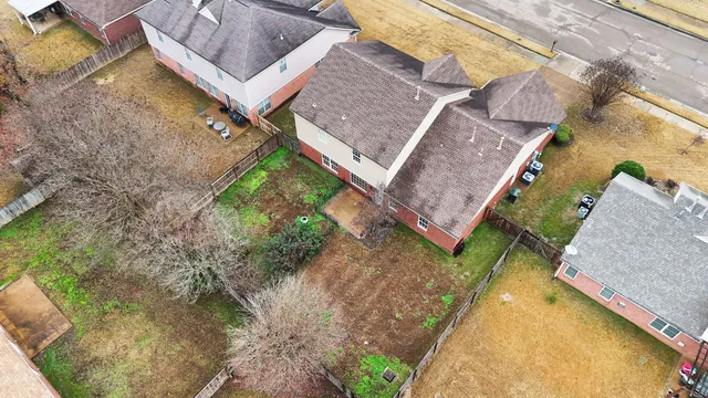 an aerial view of residential building with parking