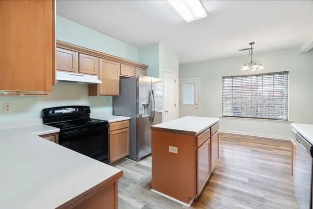a kitchen with a stove and a refrigerator