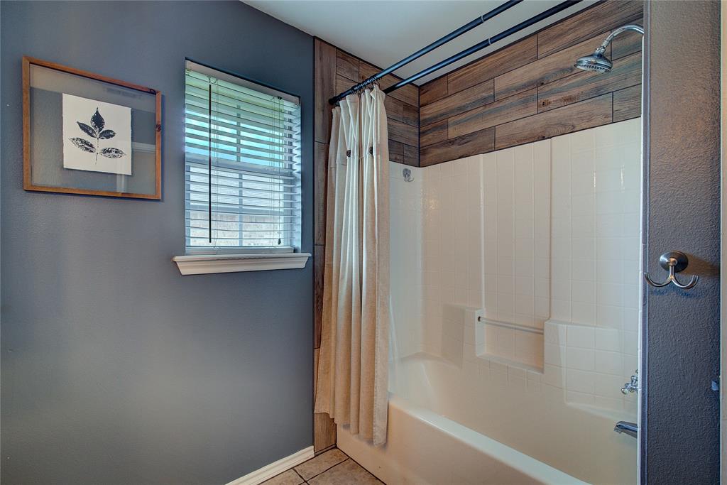 2027 Park Springs Road Sulphur Springs, TX 75482 - Photo 29 of 39 a bathroom with a bathtub and a shower