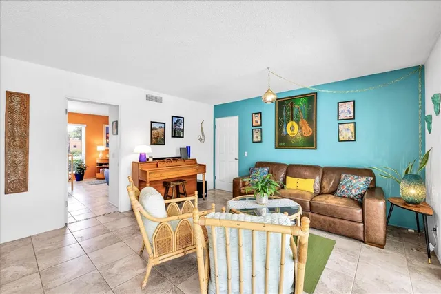 a living room with furniture and a floor to ceiling window
