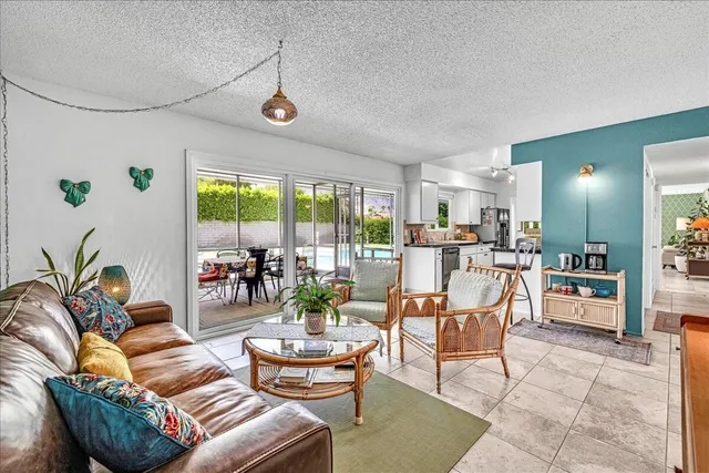 a dining room with furniture a chandelier and wooden floor
