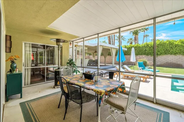 a view of a city from a dining room with a floor to ceiling window