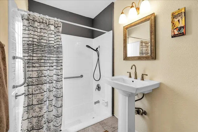 a bedroom with a bed and a lamp