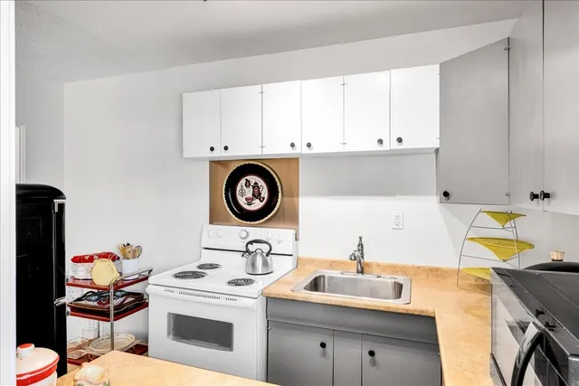 a bathroom with a sink a toilet and shower curtain