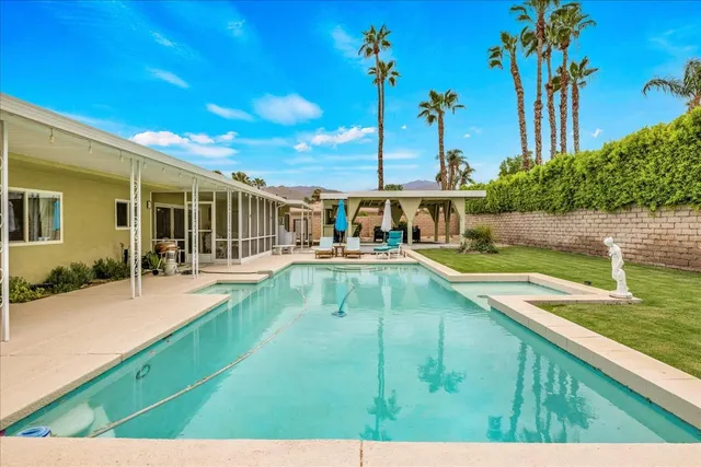 a view of a patio with table and chairs with wooden floor and fence
