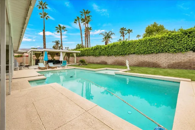 a view of a patio with a table and chairs