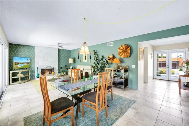 a living room with furniture a rug and a large window
