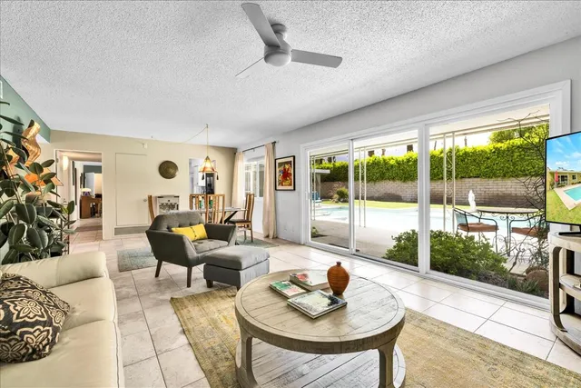 a bedroom with furniture and a large window
