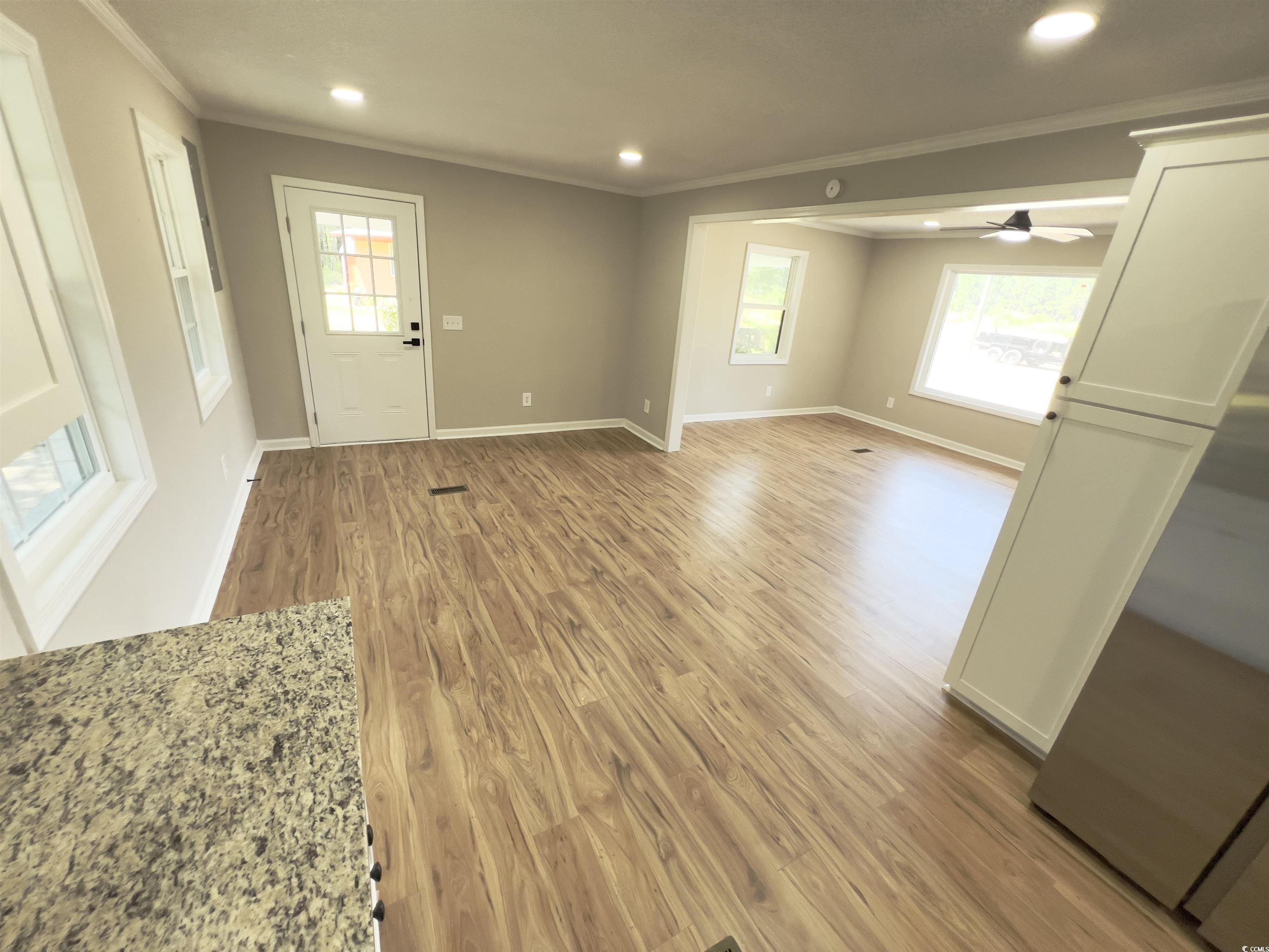 342 Lee Street Scranton, SC 29591 - Photo 4 of 22 Entrance foyer featuring crown molding, light wood-style flooring, plenty of natural light, ceiling fan, and recessed lighting