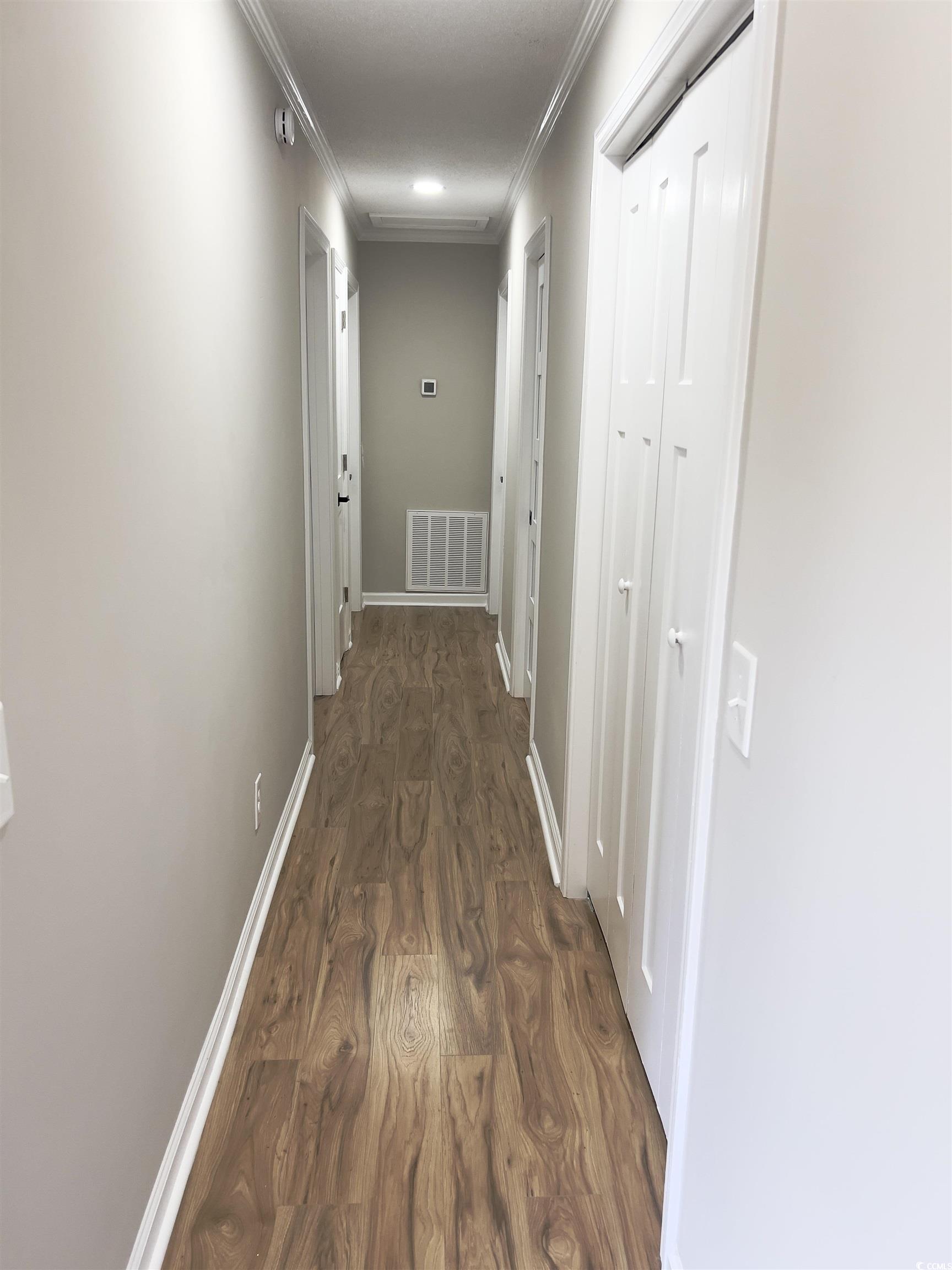 342 Lee Street Scranton, SC 29591 - Photo 8 of 22 Hall with dark wood-style flooring and crown molding