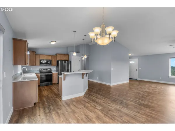 a view of kitchen and dining room with wooden floor