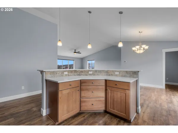 a kitchen with kitchen island a sink stainless steel appliances and cabinets