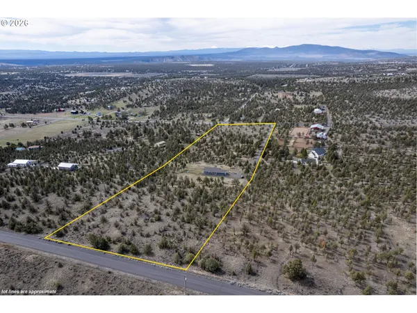 an aerial view of residential houses with city view