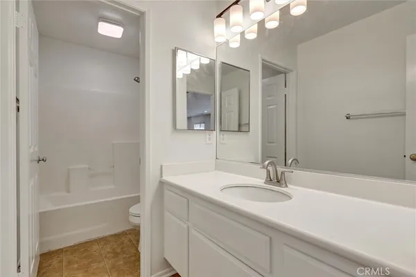 a bathroom with a sink a tub and a mirror