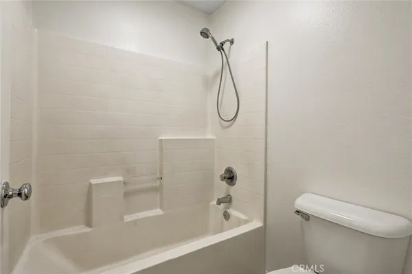 a bathroom with a shower and a toilet