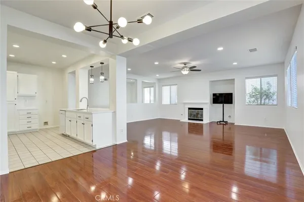 a view of a living room and kitchen with a flat screen tv