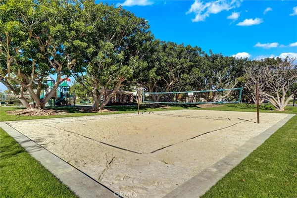 a view of a tennis ground with trees in the background