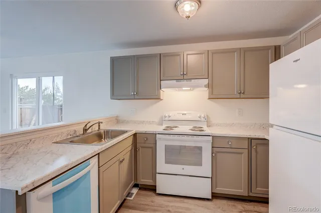 a kitchen with a sink stove and cabinets