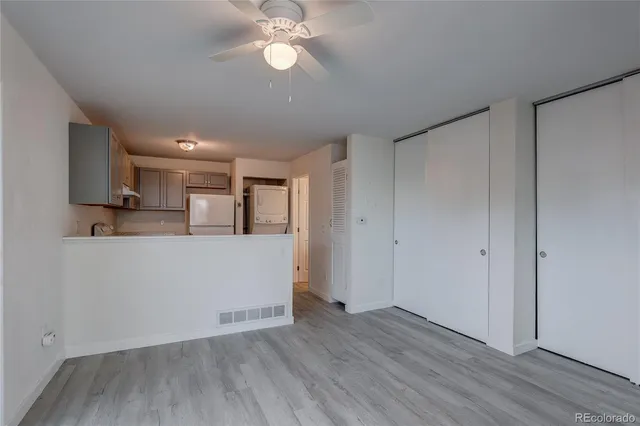 a view of a kitchen with wooden floor and a sink