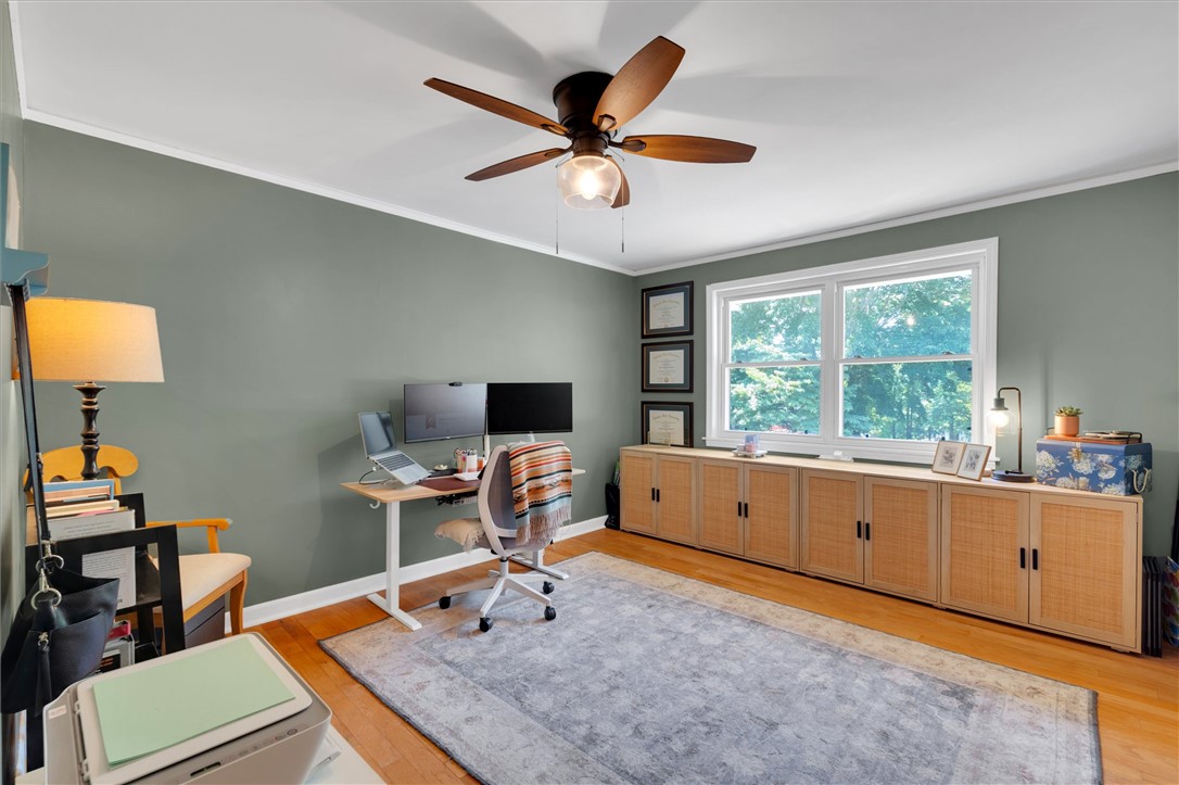 1815 Pearman Dairy Road Anderson, SC 29625 - Photo 14 of 35 A productive home office, bathed in natural light, offers ample storage and a wood-bladed ceiling fan.