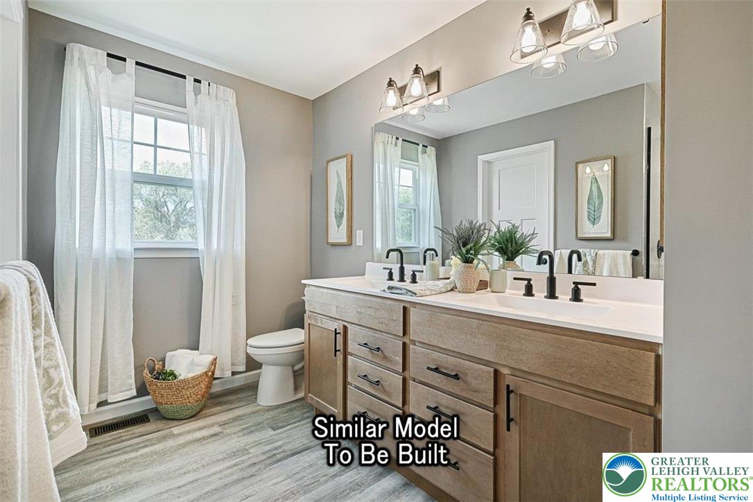 2010 Settlers Ridge Road, Unit LOT 4 Slatington, PA 18080 - Photo 16 of 20 a spacious bathroom with a double vanity sink a mirror and a shower