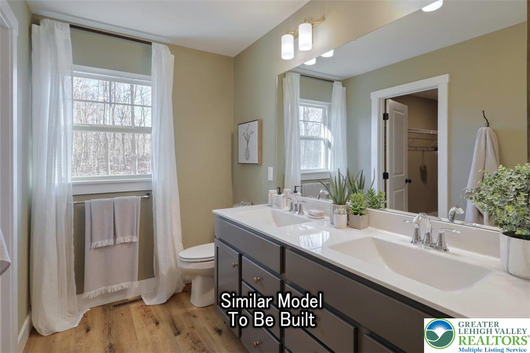 2010 Settlers Ridge Road, Unit LOT 4 Slatington, PA 18080 - Photo 17 of 20 a bathroom with a sink a toilet and a large mirror