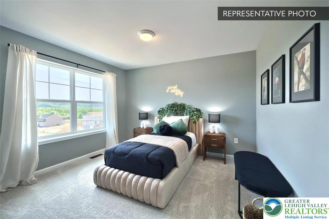 2010 Settlers Ridge Road, Unit LOT 4 Slatington, PA 18080 - Photo 19 of 20 a bedroom with a bed window and a couch