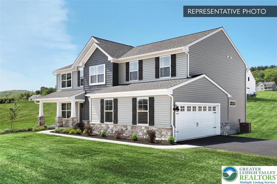 2010 Settlers Ridge Road, Unit LOT 4 Slatington, PA 18080 - Photo 2 of 20 a front view of a house with a yard and garage
