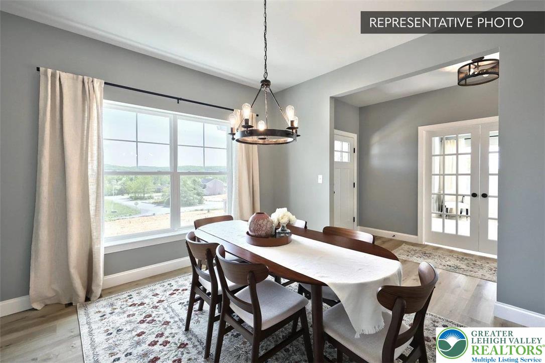 2010 Settlers Ridge Road, Unit LOT 4 Slatington, PA 18080 - Photo 6 of 20 a dining room with furniture a chandelier and wooden floor