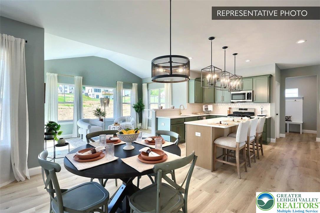 2010 Settlers Ridge Road, Unit LOT 4 Slatington, PA 18080 - Photo 8 of 20 a view of a dining room and livingroom with furniture wooden floor a chandelier
